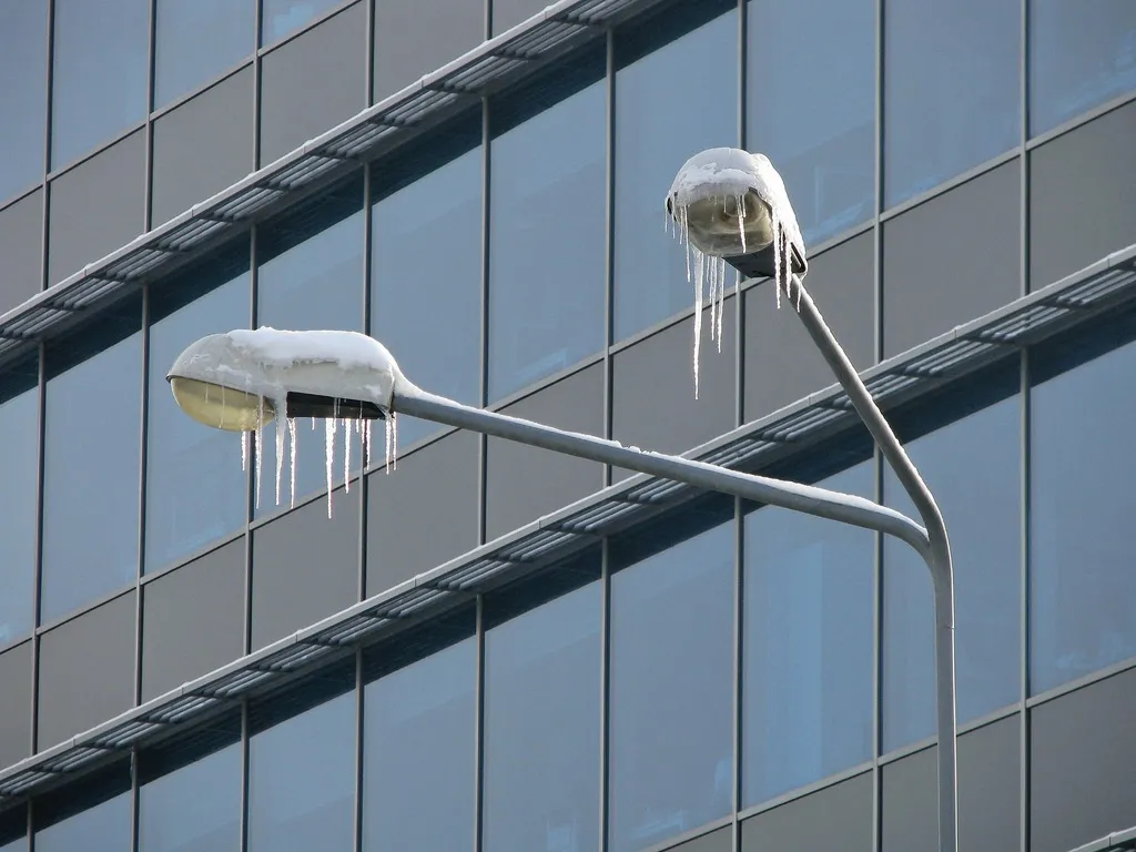 frozen street lights and an all glass building
